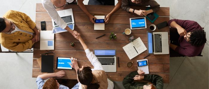 Group of people sitting around table at business meeting